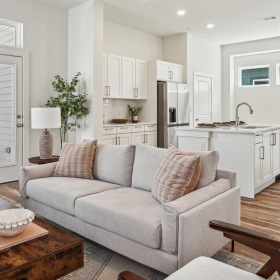 Settle into comfort at Canvas at Anna a living room with a couch and a table