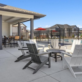 Resident-exclusive access to stunning outdoor patio  a patio with tables and chairs