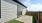 patio with a fence and grass