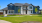 A large duplex home with front yard