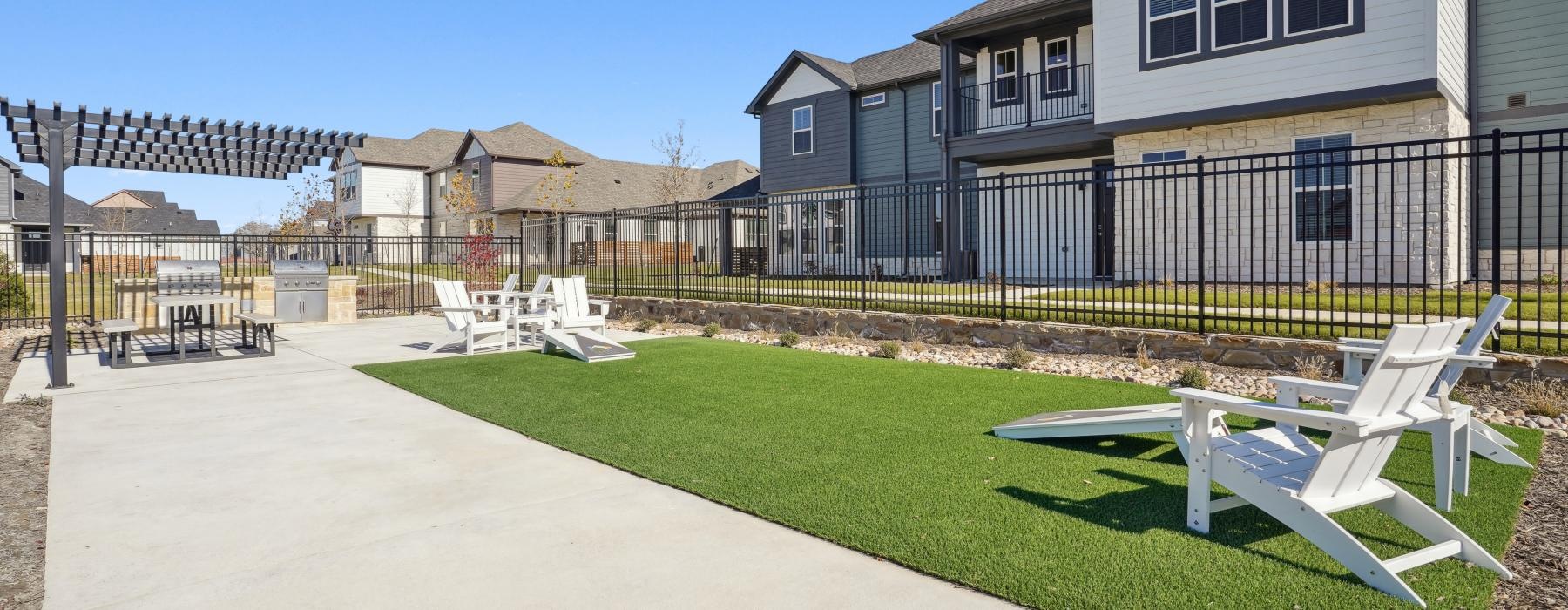 a backyard with a pool and chairs