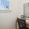 a desk with a chair and a painting on the wall