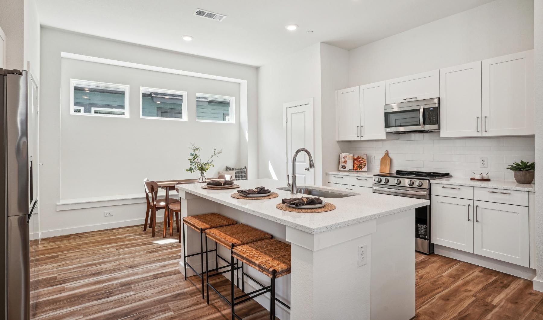 Spacious kitchens with thoughtful details a kitchen with white cabinets
