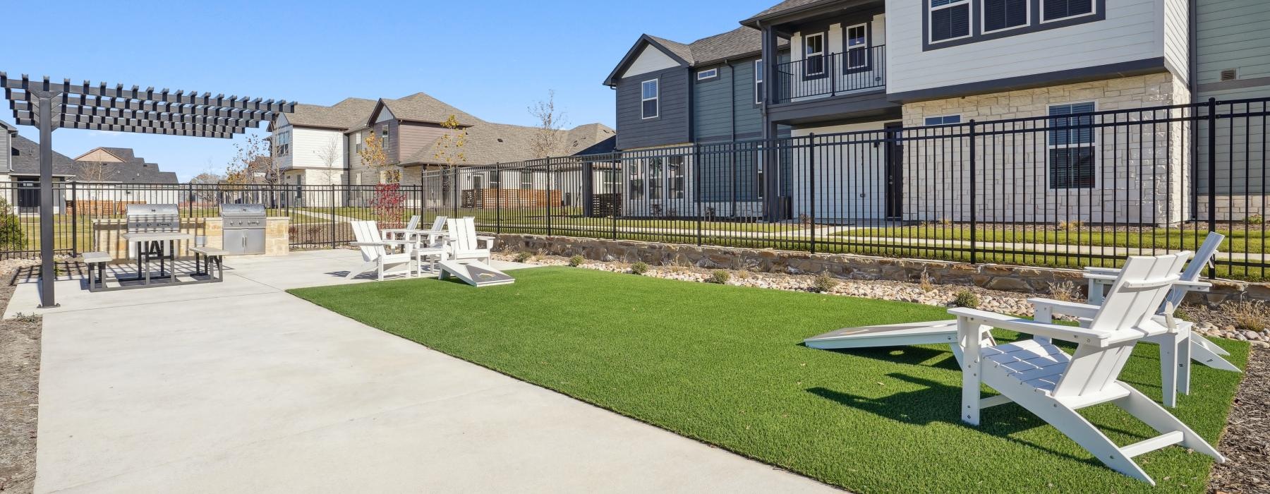 a backyard with a pool and chairs