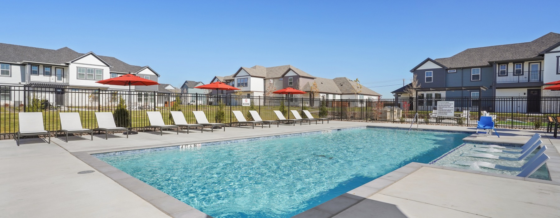 a resort inspired pool with tanning chairs